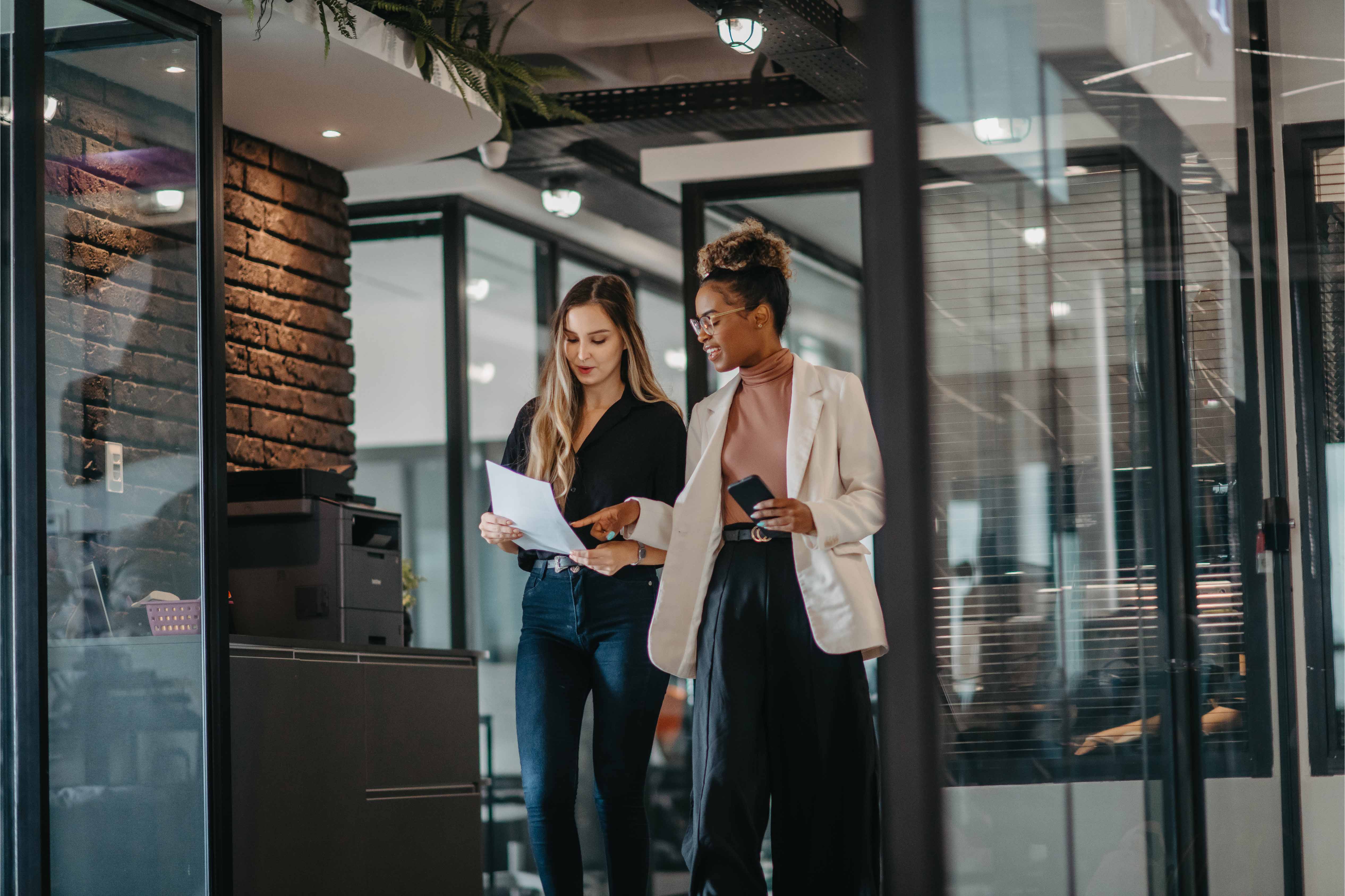 Young female employees walking down the company corridor