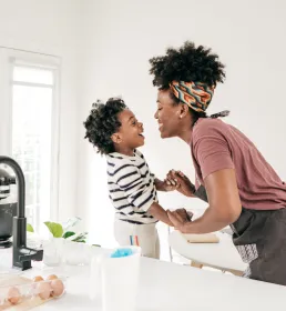 Mom and kid having fun in kitchen