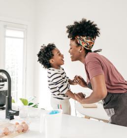 Mom and kid having fun in kitchen