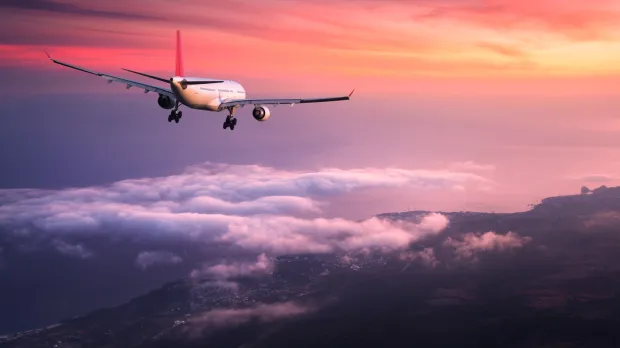 Aeroplane in the sky at sunset Aeroplane in the sky