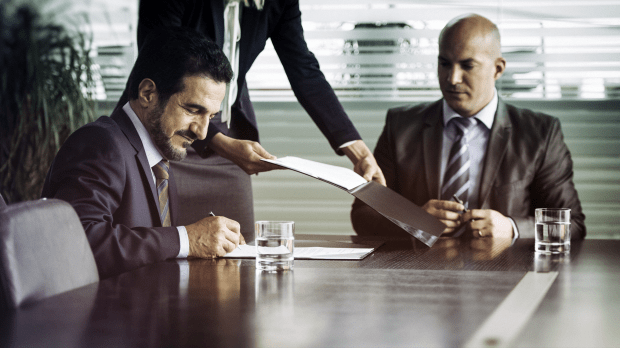 businessmen sitting around table 