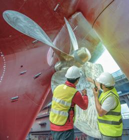 Men fixing a ship's hull 