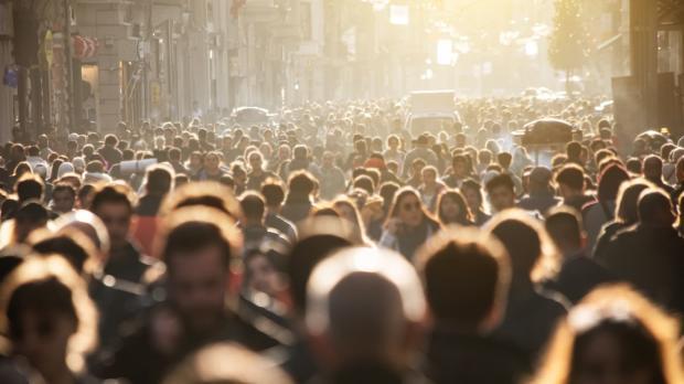 Hundreds of people walk in a crowded street in Thailand
