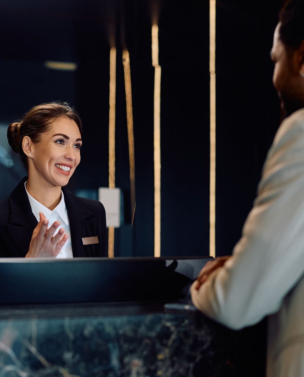 hotel receptionist greeting guest