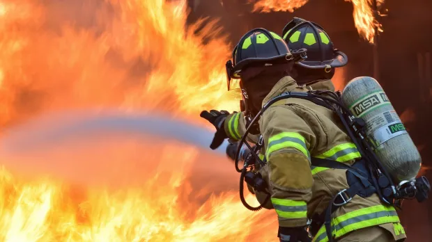 Two firemen fighting wildfire 