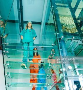 Doctors walking on glass staircase
