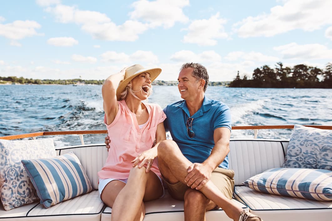 Wealthy couple laughing on a boat