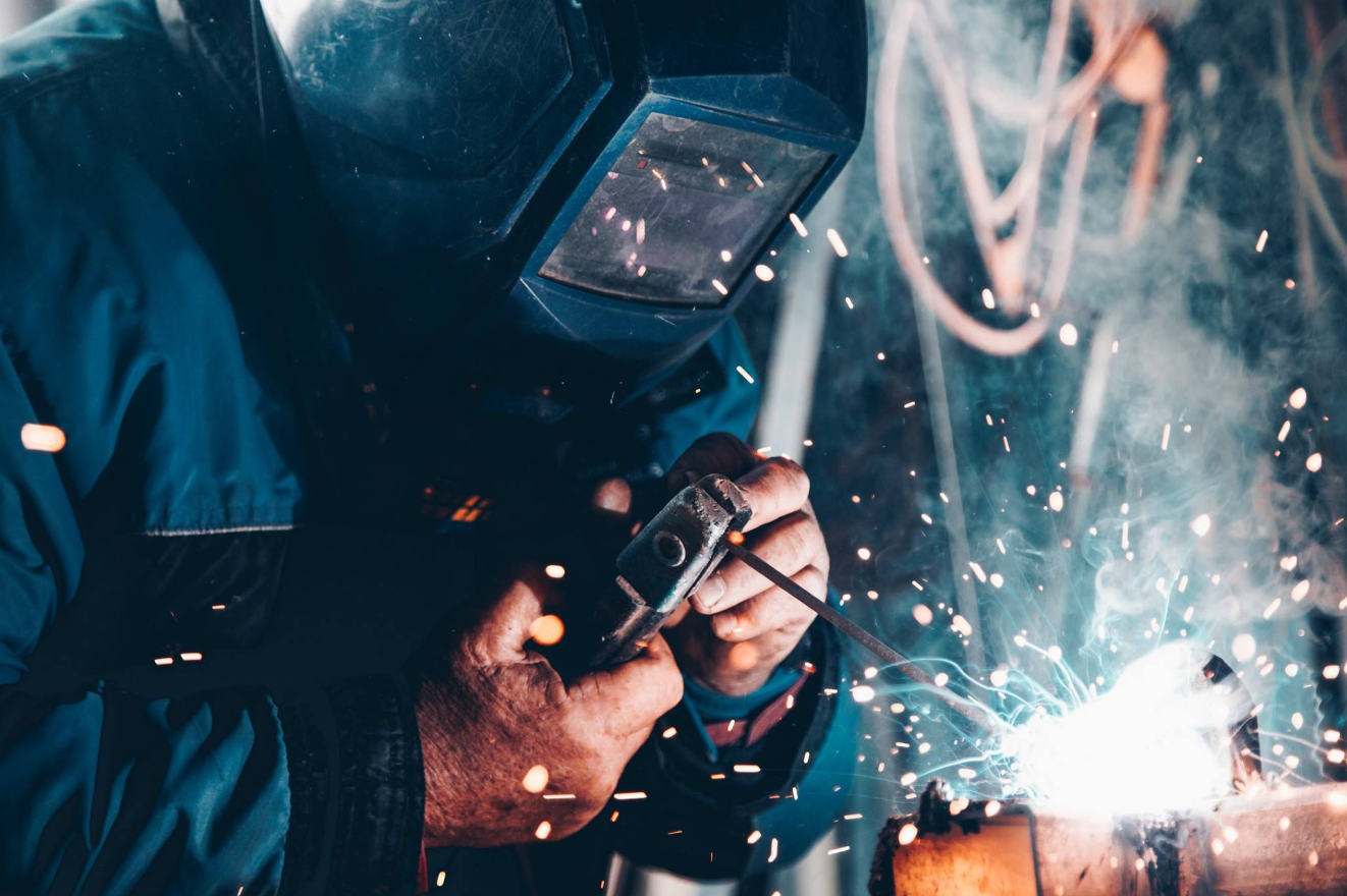 A welder is working, with sparks flying
