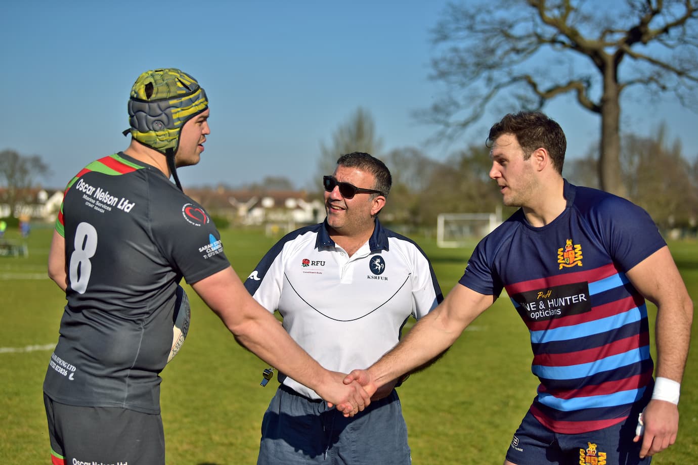 Rugby referee officiating the coin toss 