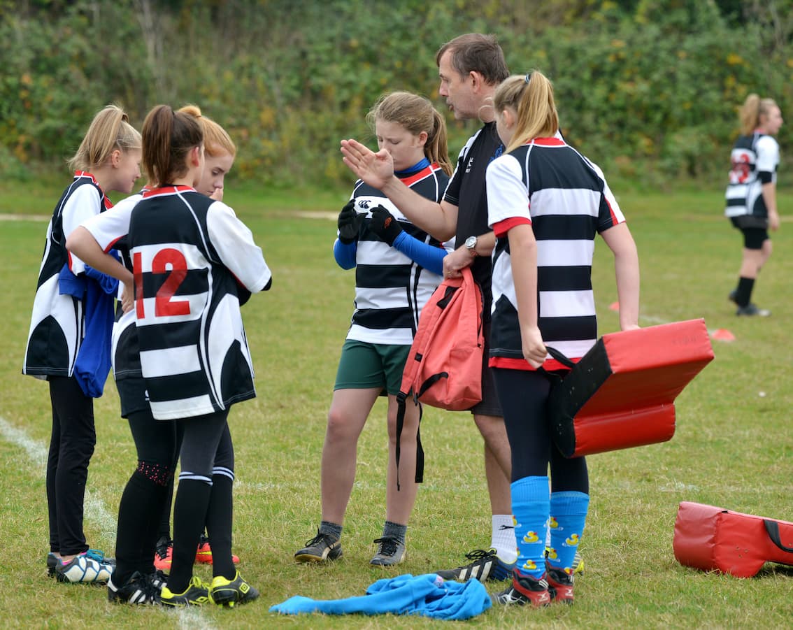 Children having rugby team talk