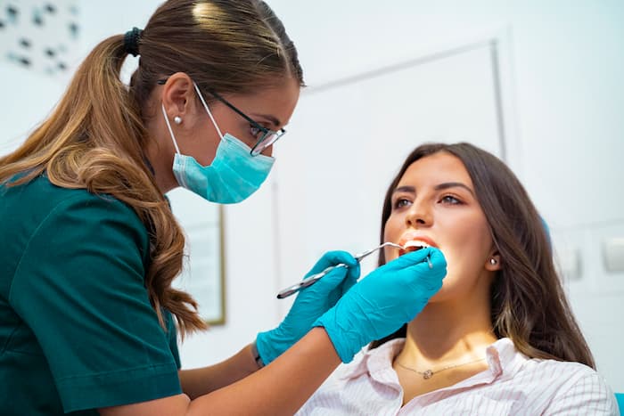 Female dentist looking into a patients mouth 