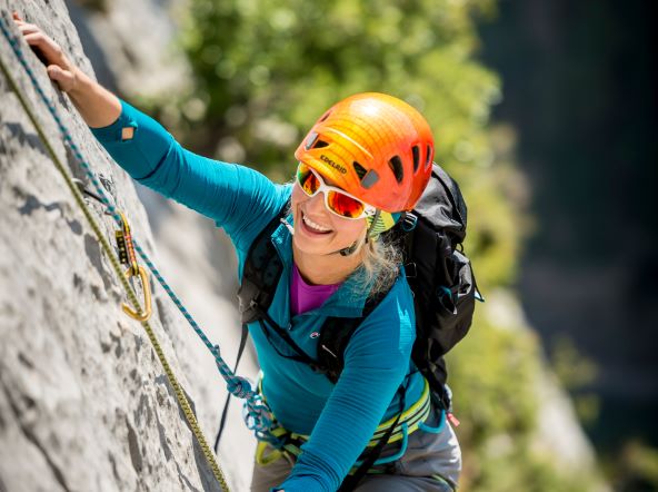 A climber climbing up a cliff