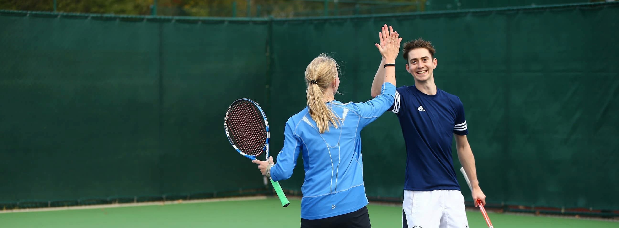 Mixed doubles partners high fiving