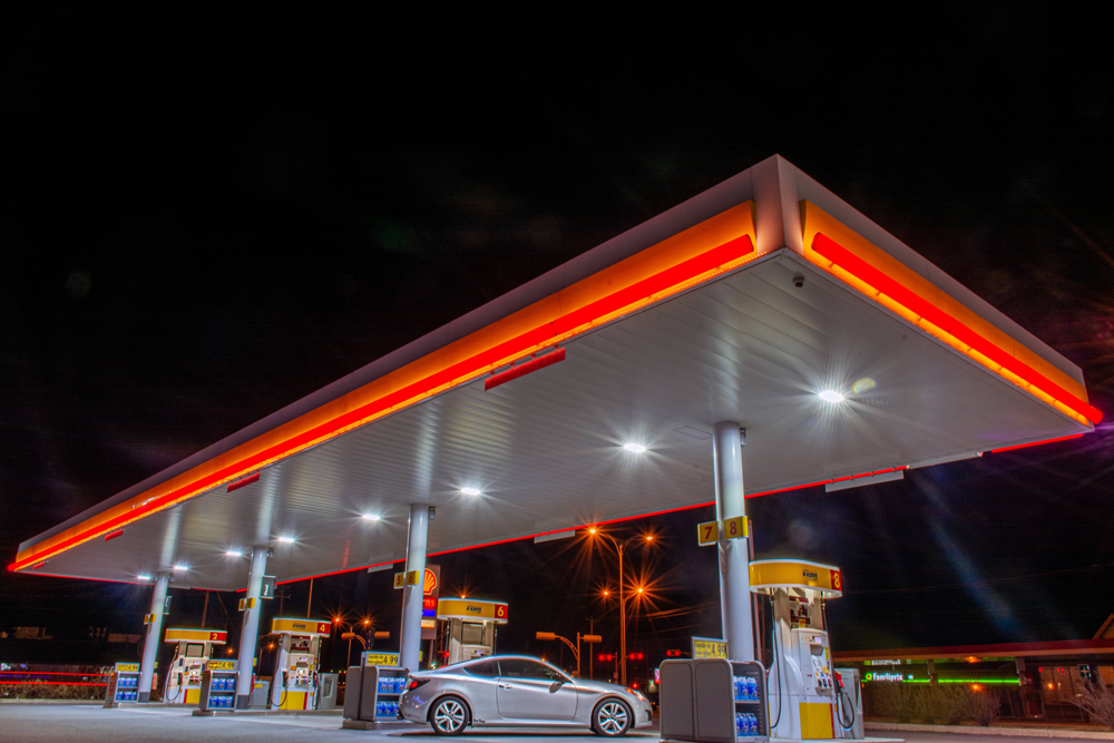 A petrol station forecourt at night