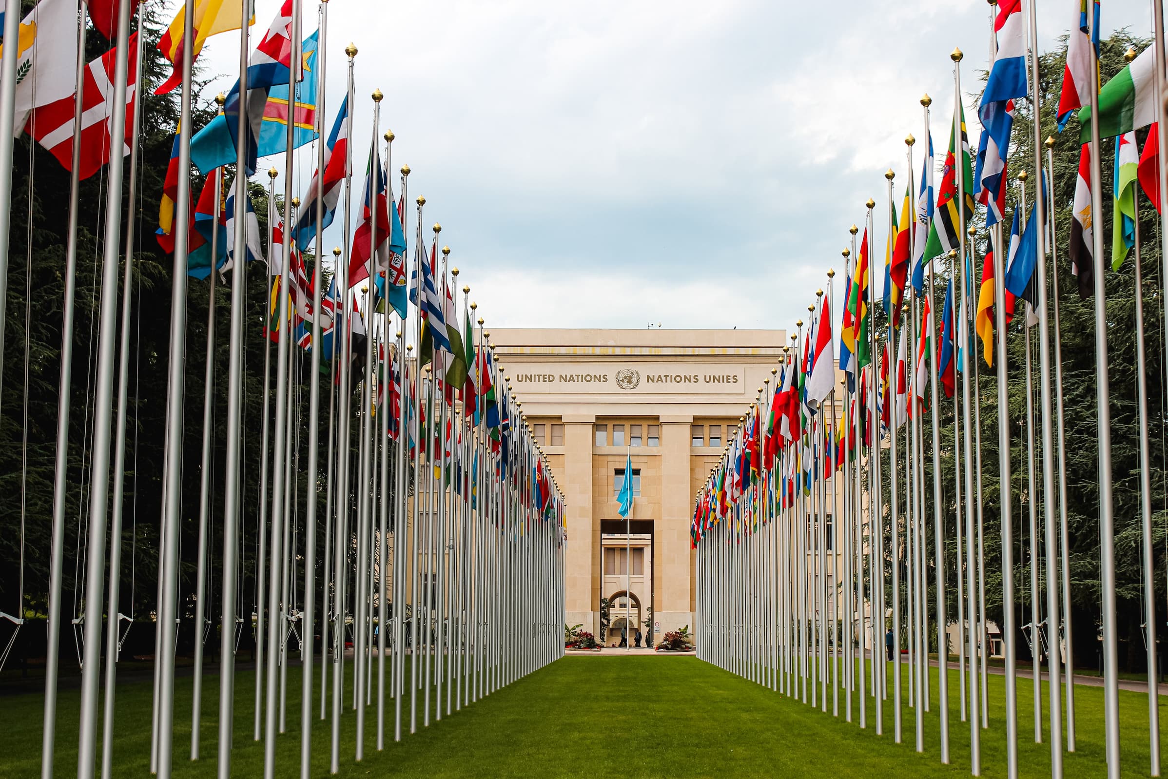 United nations' flag lined grass pathway leading to entrance