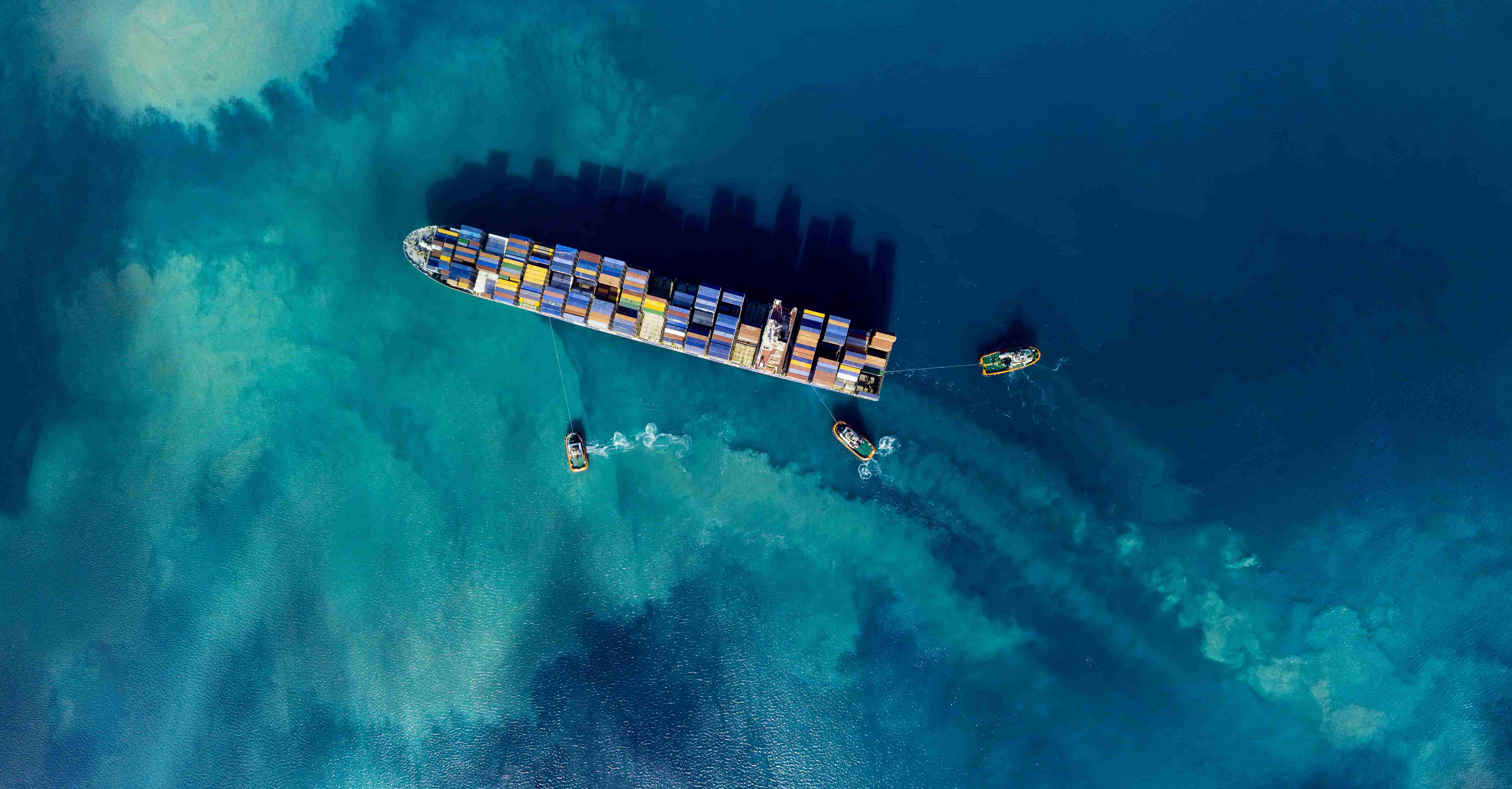 Image of a cargo ship in the water from above