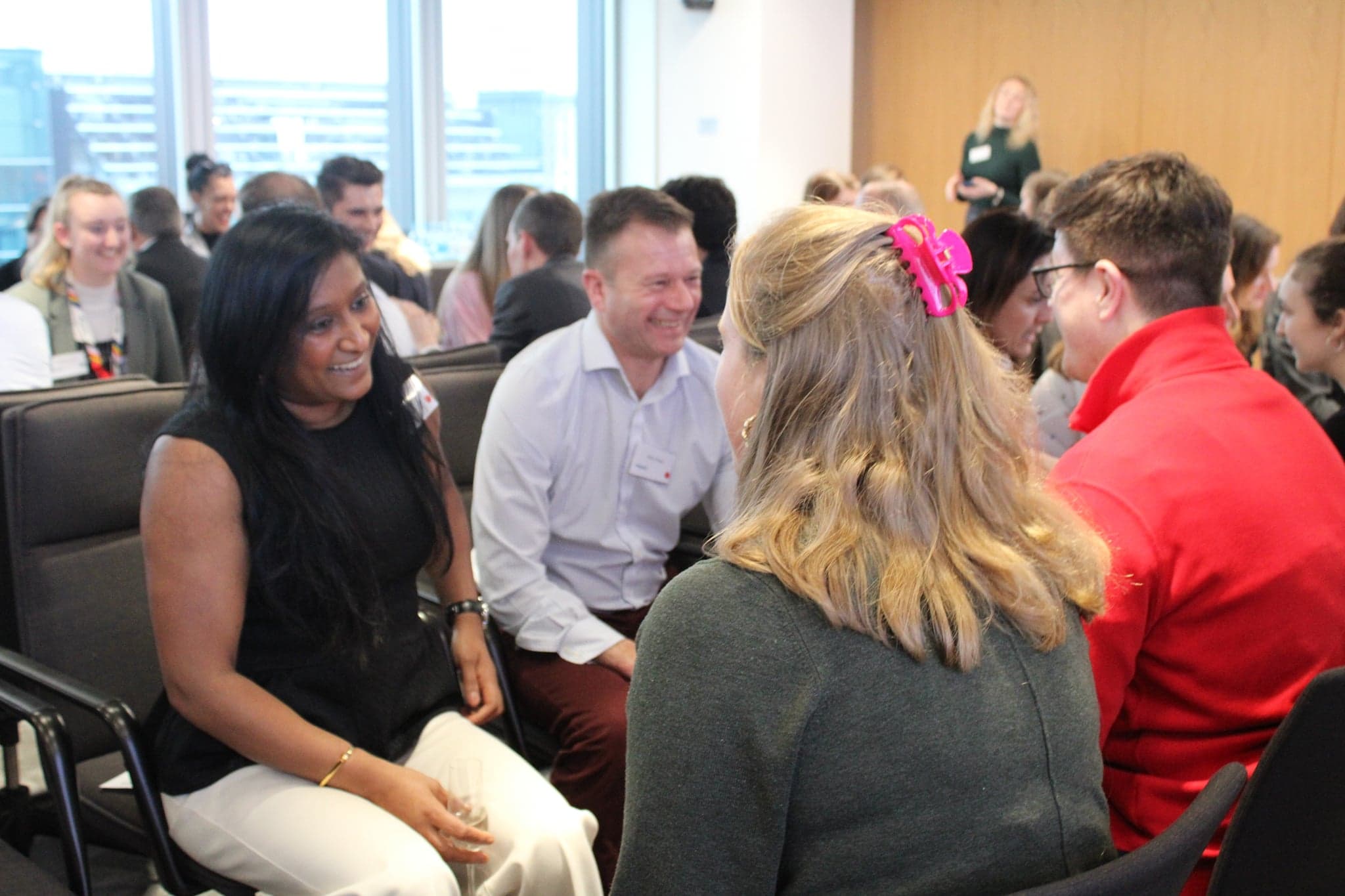Two colleagues laughing together during the speed networking event