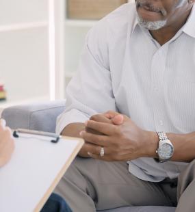 A therapist makes notes as her client speaks