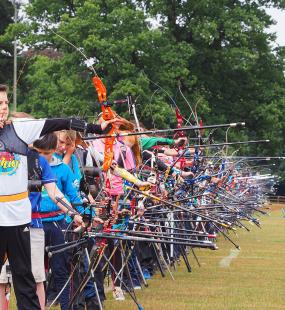 Archery club firing arrows
