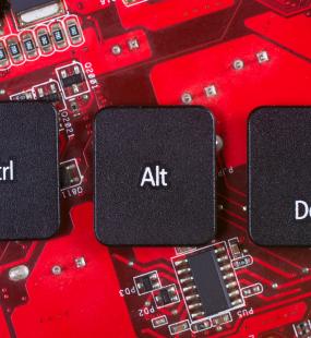 Control, alt and delete keys sitting on circuit board