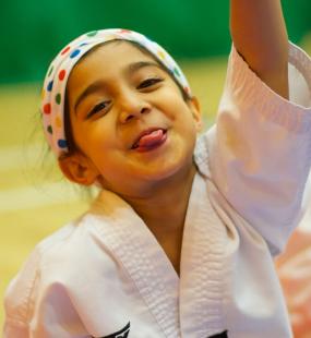 Happy young girl in Taekwondo gear