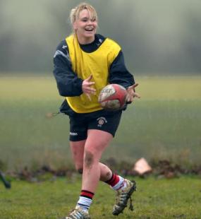 Girl in bib playing rugby