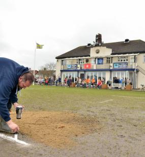 Marking the pitch outside the club house