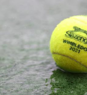 Tennis ball in a puddle on court