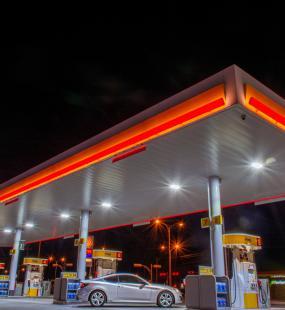 A petrol station forecourt at night
