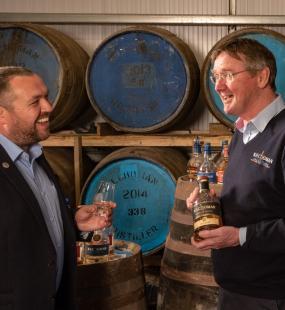 Two men talking in a distillery