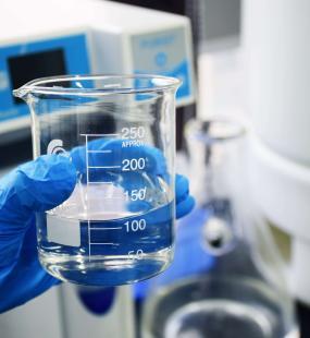 A beaker of chemicals in a lab