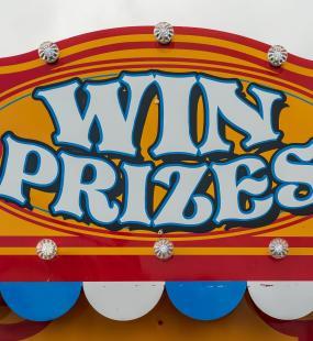 Colourful carnival sign which reads win prizes