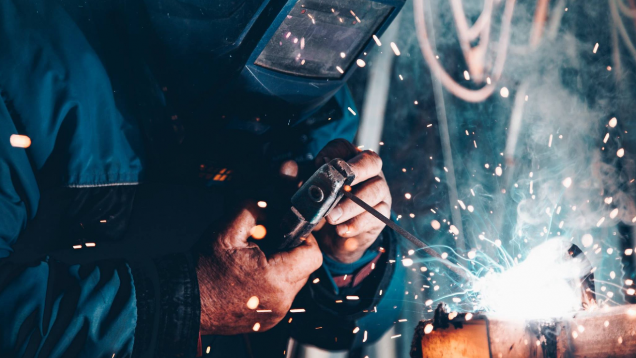A welder is working, with sparks flying