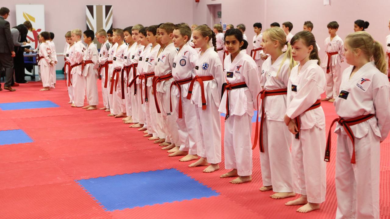 A row of children ready to do Taekwondo 