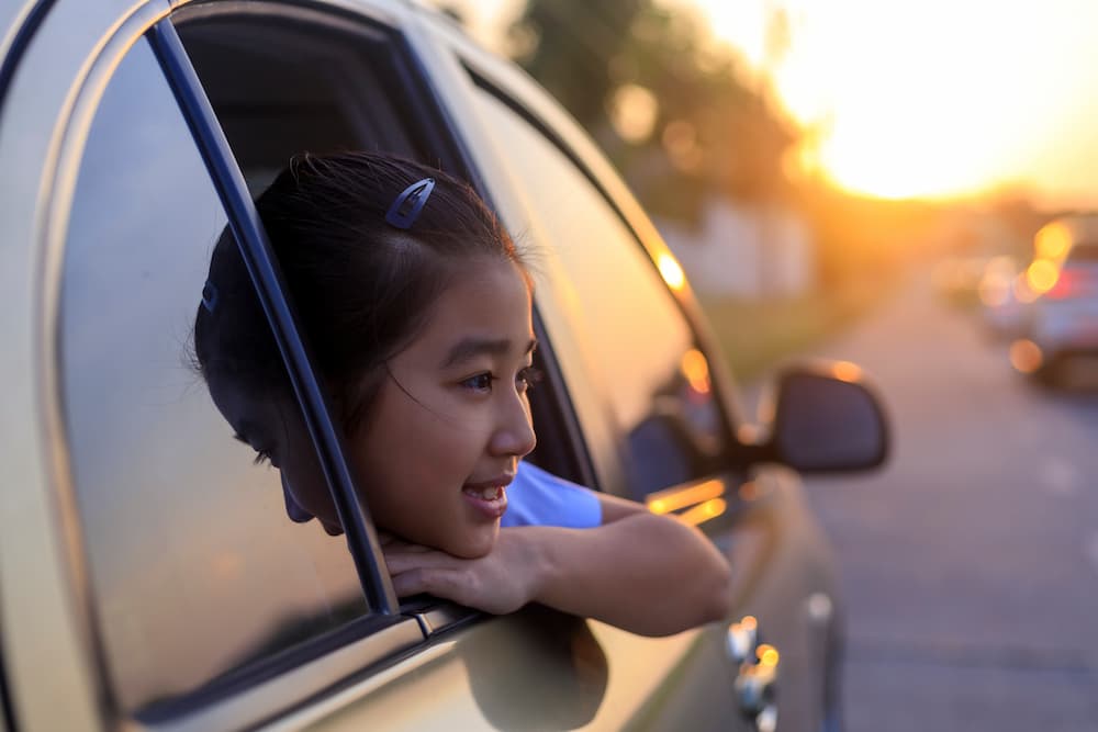 Young girl looking out car window