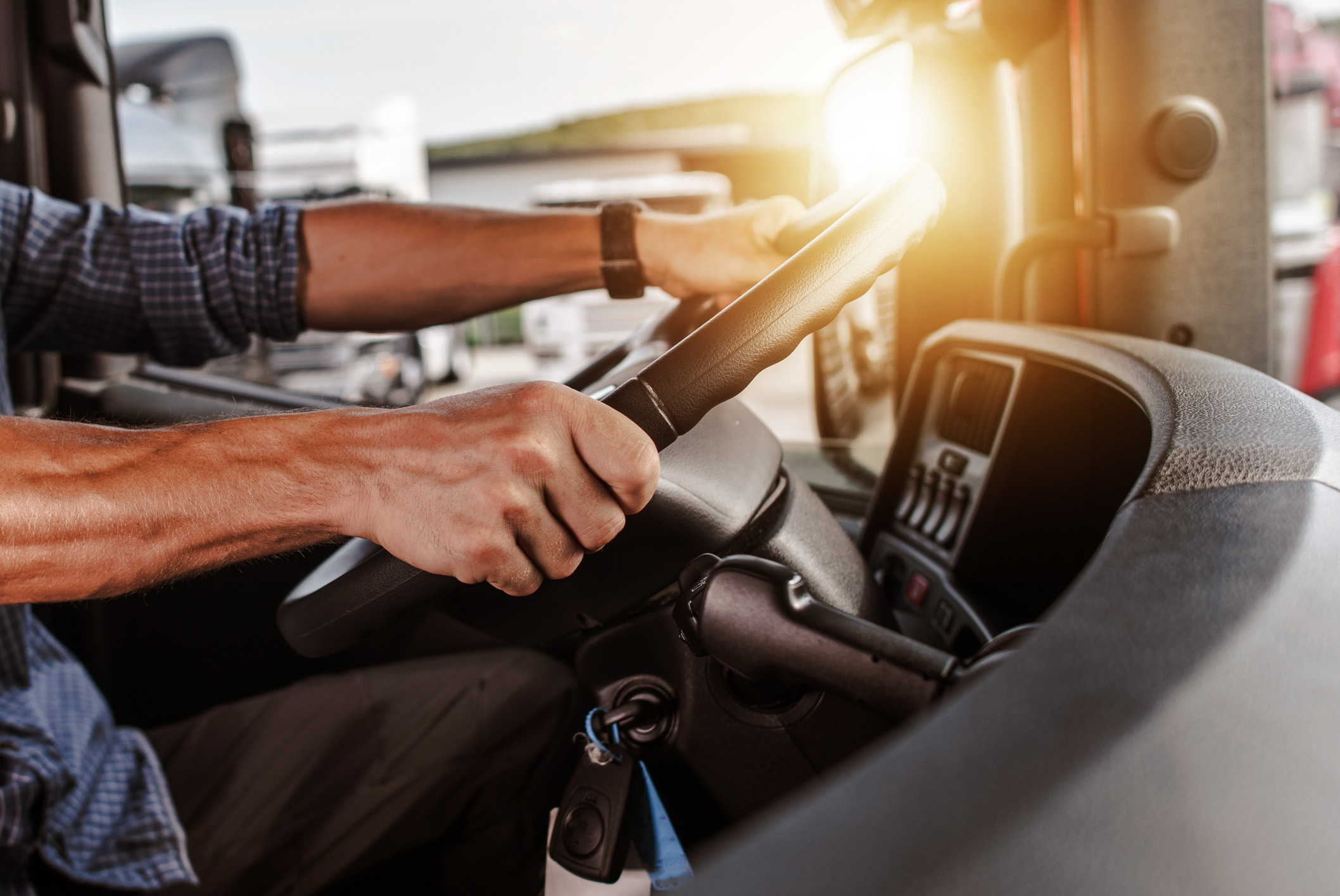 Driver at the wheel of a van at sunset
