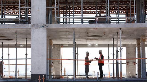 Two men talking on a building site