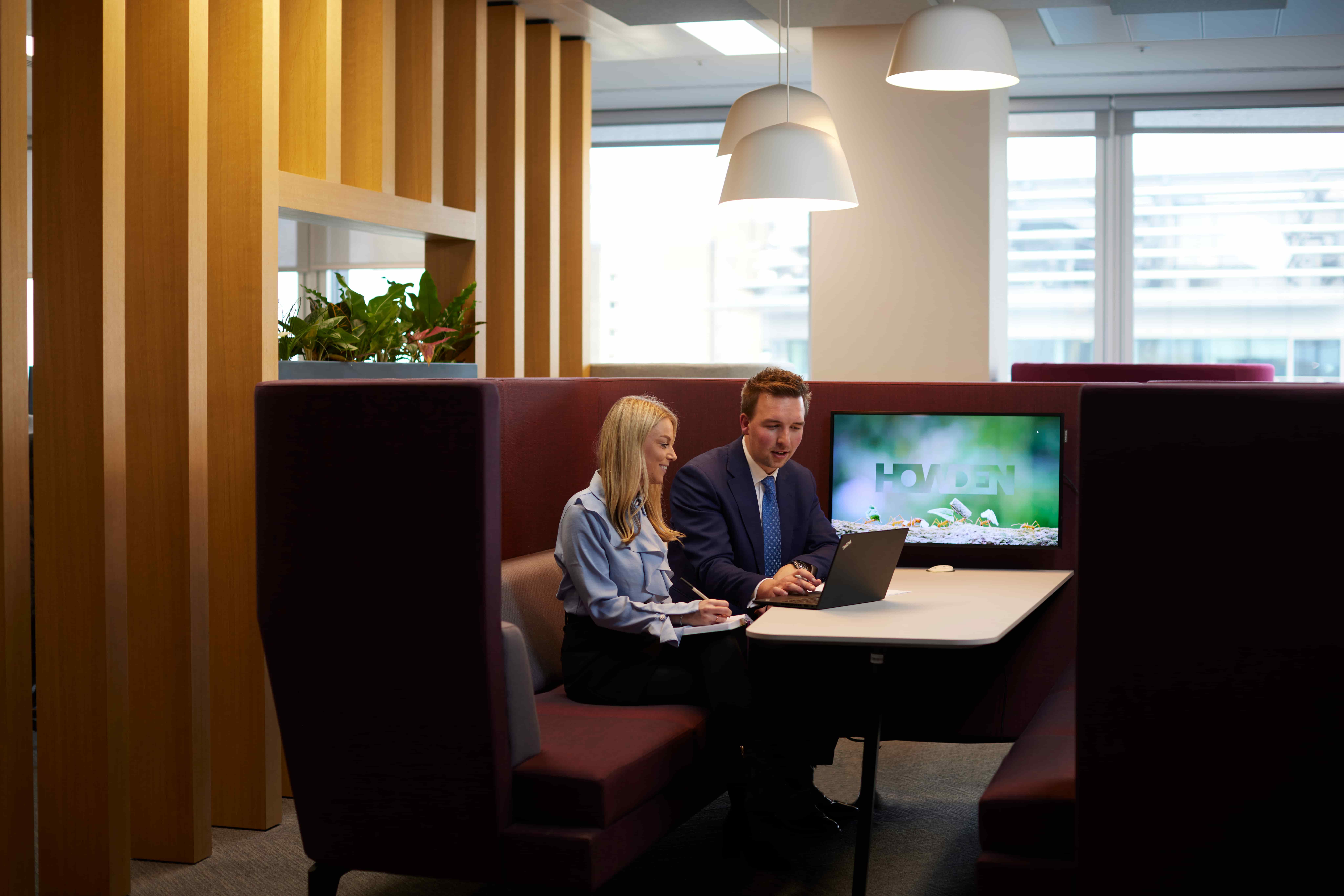 two people talking with laptop