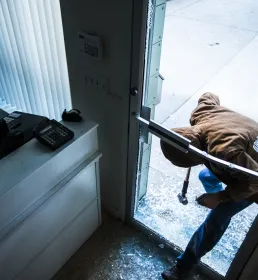 A robber breaks in to a business using a sledgehammer