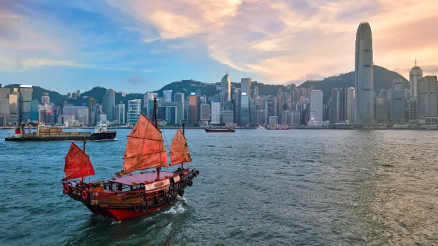 Traditional junk boat sailing across Victoria Harbour