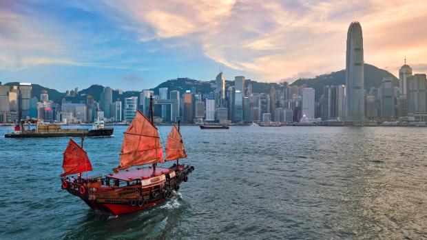 Traditional junk boat sailing across Victoria Harbour