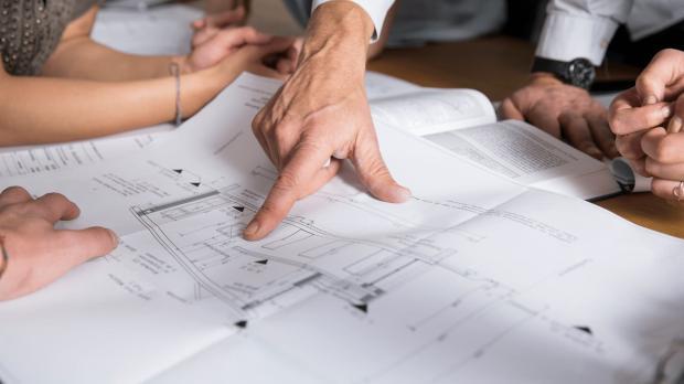 staff looking at plans