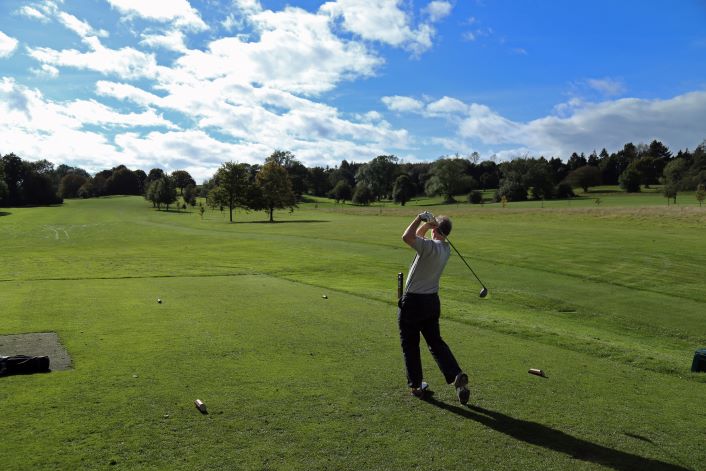 Image of man playing on golf course