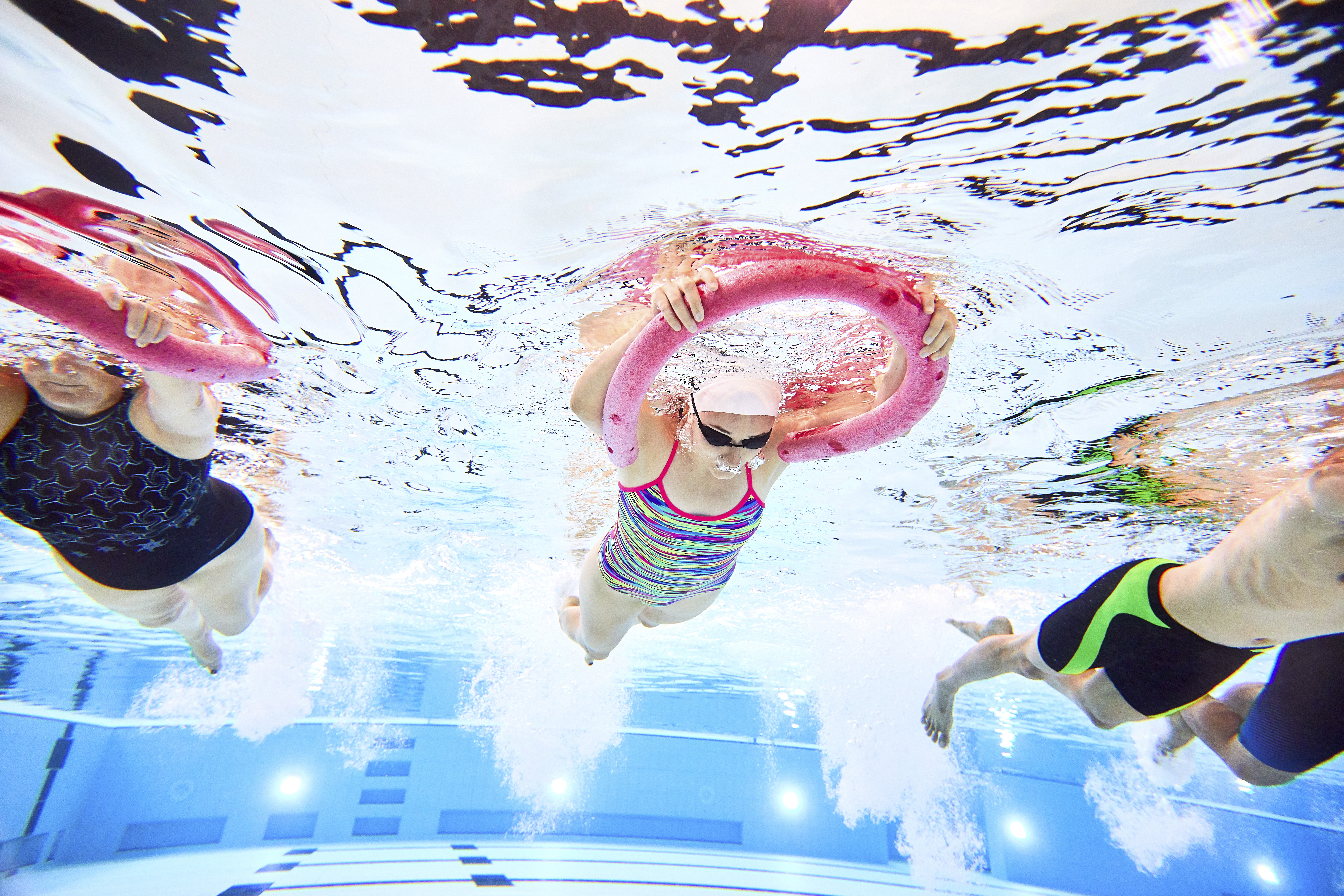 Under water shot of people swimming