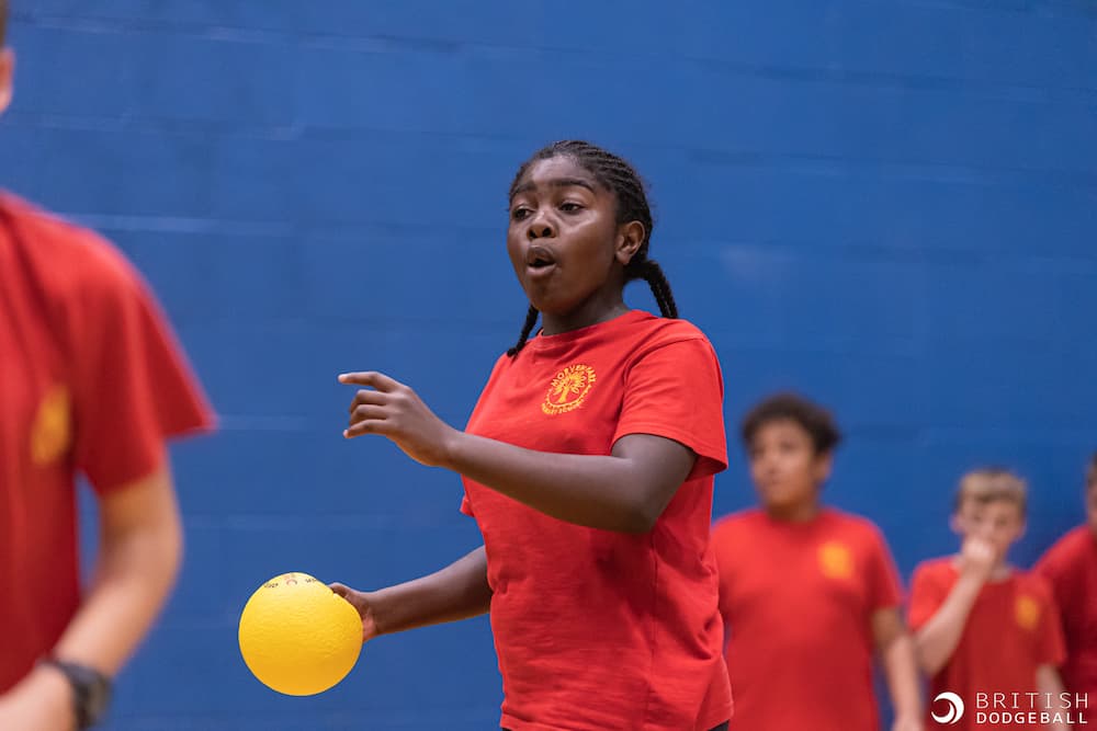 Girl about the throw dodgeball