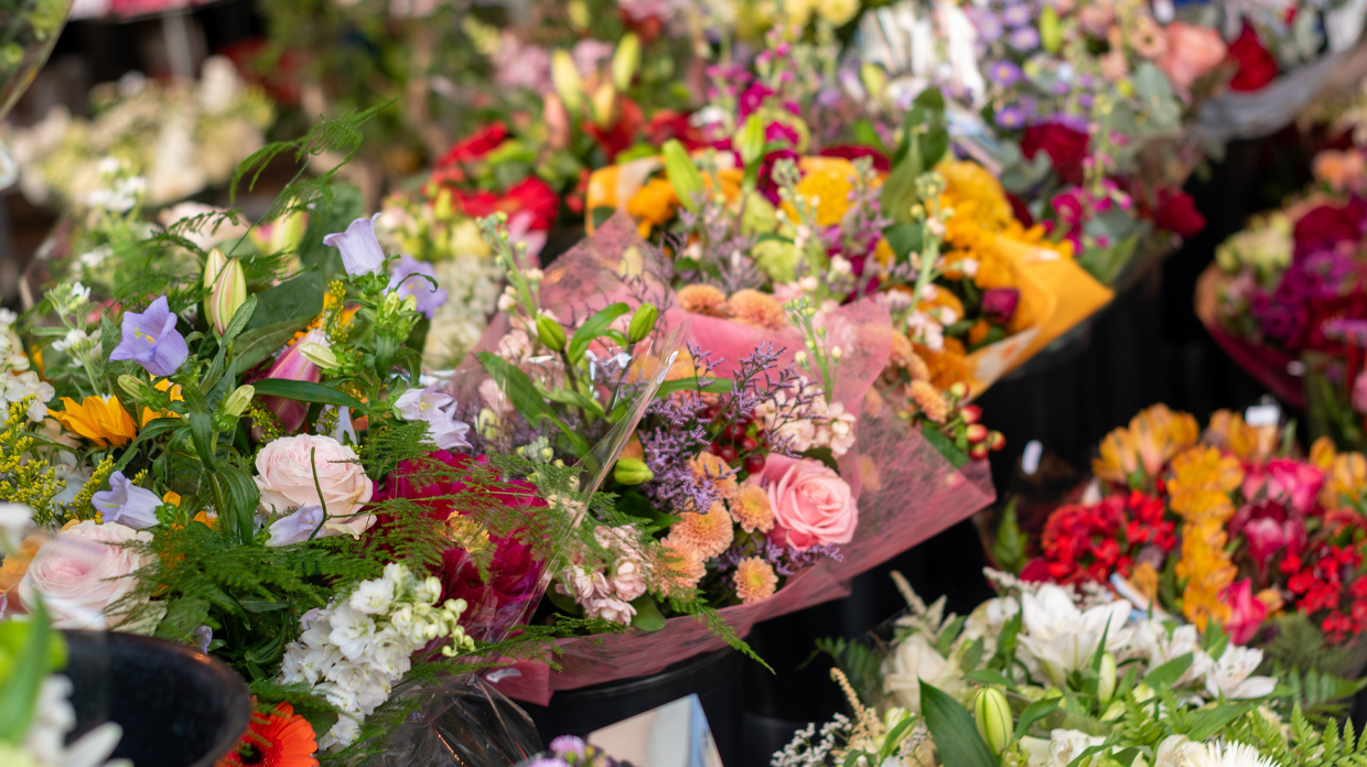 A vibrant bouquet of assorted flowers, showcasing a variety of colors and shapes, arranged beautifully in a vase.
