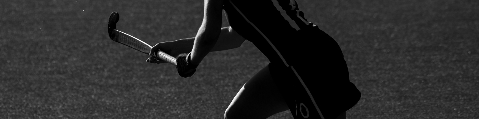 Female hockey player with raised hockey stick