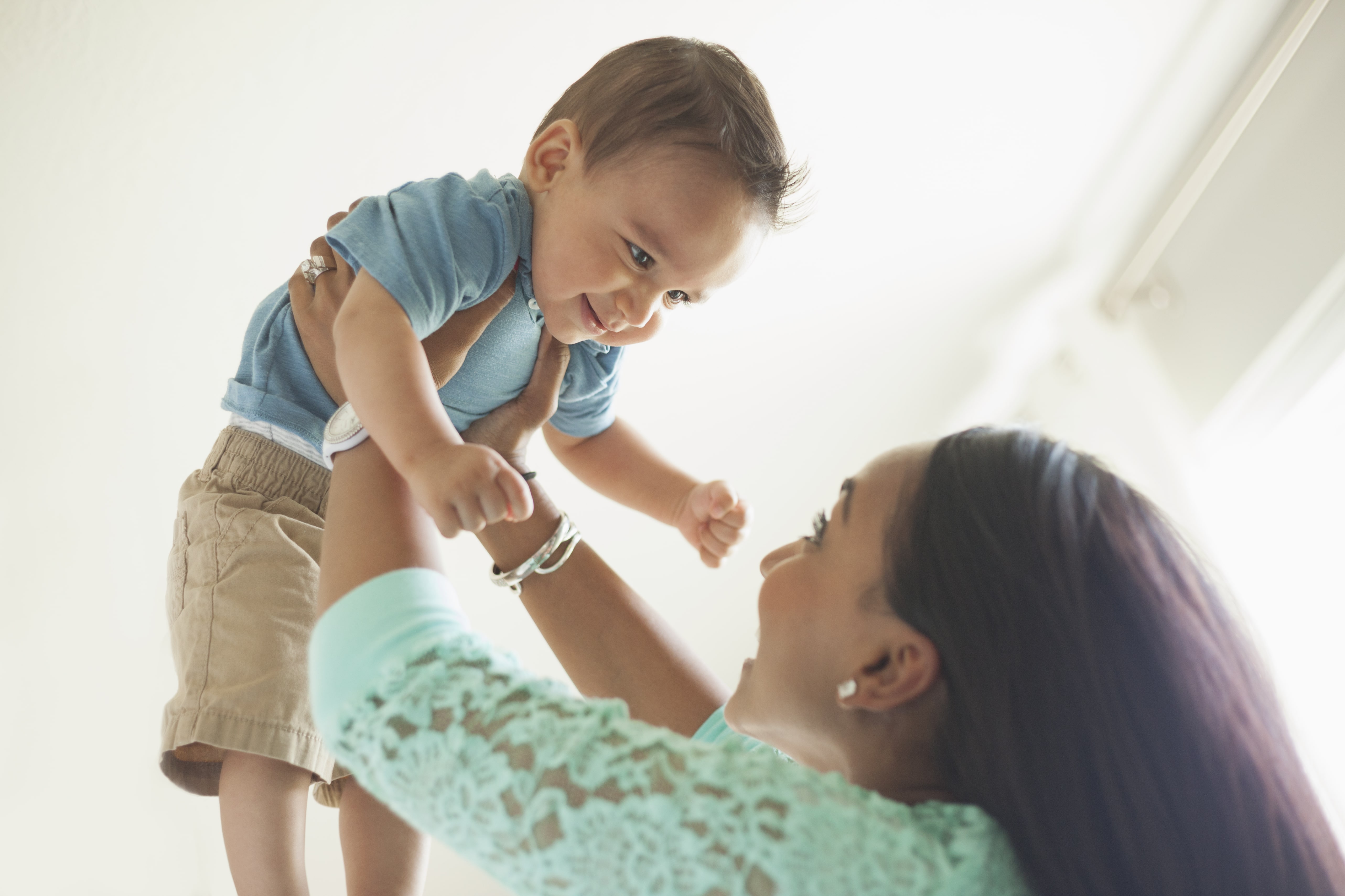 Mom playing with baby in the air