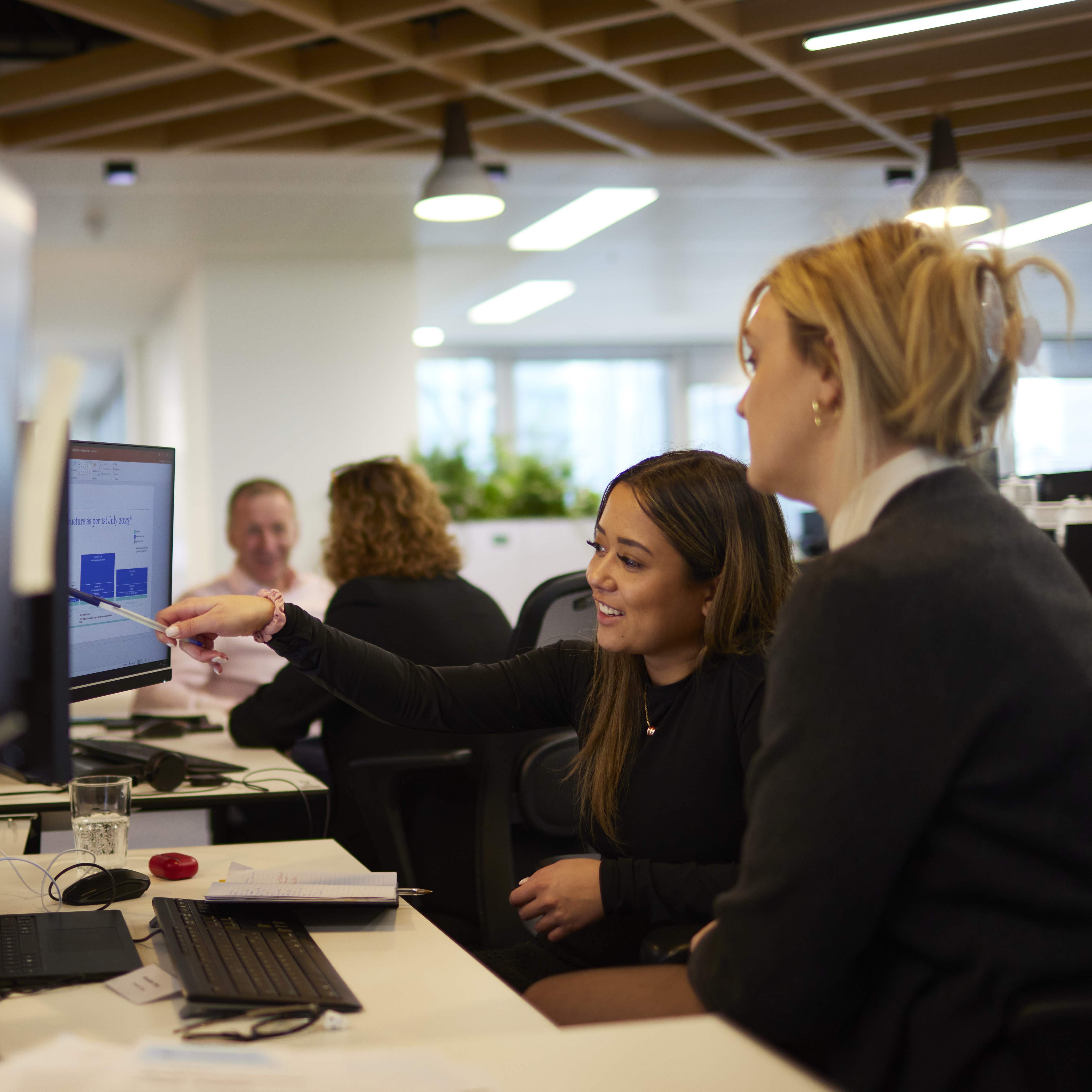 Howden team at desk showing screen
