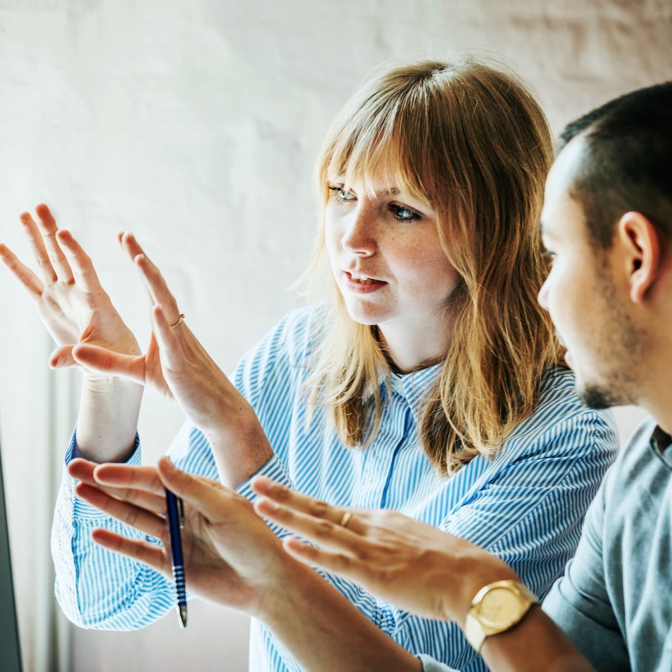 Two colleagues talking and using animated hand movements